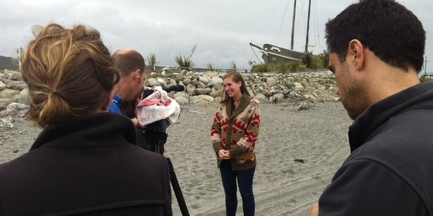Eleanor Catton in front of the cameras on the beach at Hokitika during her fundraising visit.