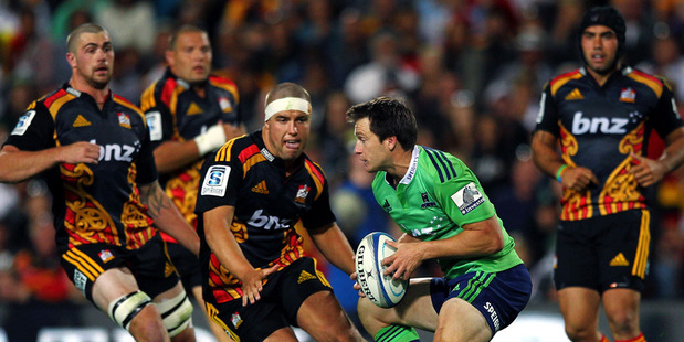 Ben Smith of the Highlanders makes a run at Rhys Marshall of the Chiefs. Photo / Getty Images