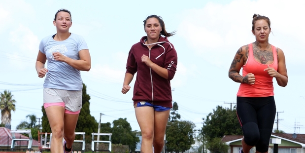MAKING TRACKS: Northland Outward Bound ambassador Amelia Herbert (left) with Jessica Friis and Louisa Dobbs, warm up ahead of the Outward Bound Fun Run at Kensington Park's athletic track on Saturday.PHOTO/JOHN STONE