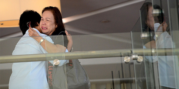 Family members of passengers aboard a missing plane cry at a hotel in Putrajaya, Malaysia. Photo / AP