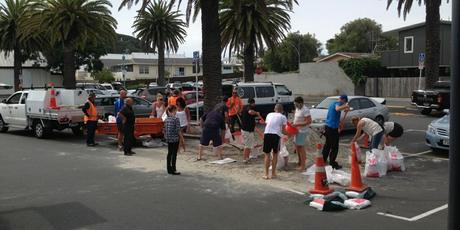 People stock pile sand bags in preparation for Cyclone Lusi