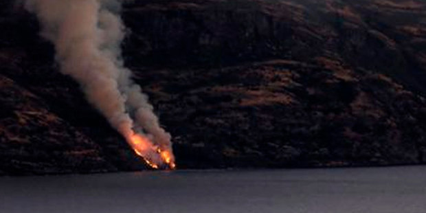 Flames seen up the incline of the isolated Cecil Peak from Steamer Wharf in Queenstown . Photo / Craig Robertson