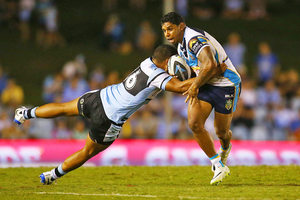 Albert Kelly of the Titans runs the ball during the round one NRL match between the Cronulla Sharks and the Titans. Photo / Getty Images