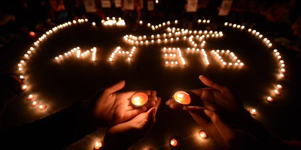 Students in Yangzhou, China, hold a vigil for those on the missing Malaysia Airlines flight. Photo / AP
