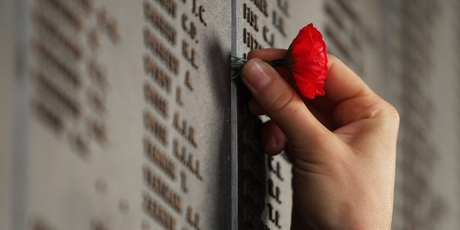 Red paper poppies inserted next to many names on the Roll of Honour show the significance for visitors.