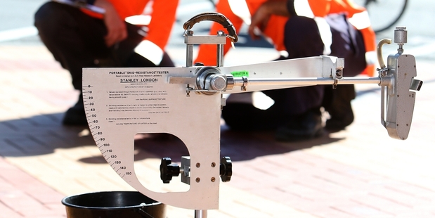 Opus International Consultants staff Andrew Rudsdale, left, and Ian Twichel use a British pendulum tester to measure the slipperiness of footpath pavers in Rathbone St. Photo / APN