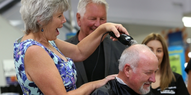 Whangarei Mayor Sheryl Mai deals to her husband's hair. Photo / APN