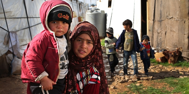 Some children, such as this girl carrying her brother, must cope without their parents.