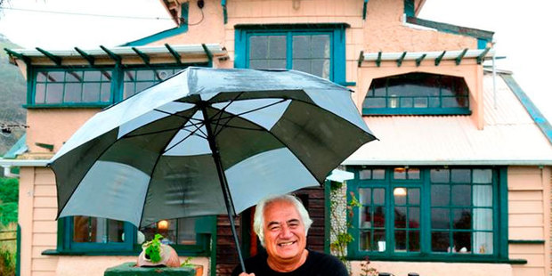 Former television personality Olly Ohlson keeps dry outside his new Otago Peninsula home yesterday. Photo / Gerard O'Brien ODT