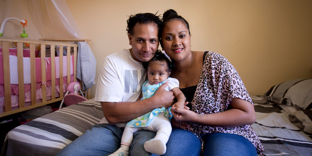 Tali Harrington with his wife Joan and baby Leila. Harrington says sharing a South Auckland state house with 14 others is stressful. Photo / Dean Purcell