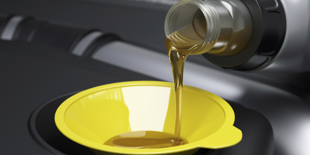 It's advisable to use a funnel when doing an oil change, to avoid messy spillage. Photo / www.jupiterimages.com