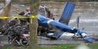 A piece of the wreckage of a news helicopter sits on a city street after crashing in Seattle. Photo / AP