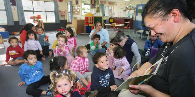 Ripeka Kireka reads a book to children at the Te Tirahou Early Childhood Education Centre at the Te Taiwhenua o Heretaunga, Hastings. Photo / Warren Buck