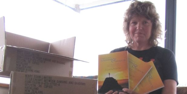 Georgie Tutt with her book Caught Between Sunshine and Shadow, will be at the Katikati Health and Wellbeing Expo on Saturday.
