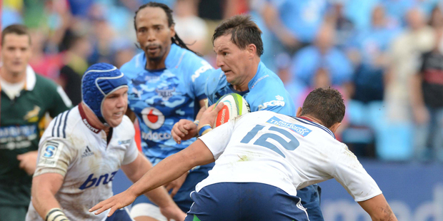 Jacques-Louis Potgieter of the Bulls is tackled by Jackson Willison of the Blues. Photo / Getty Images