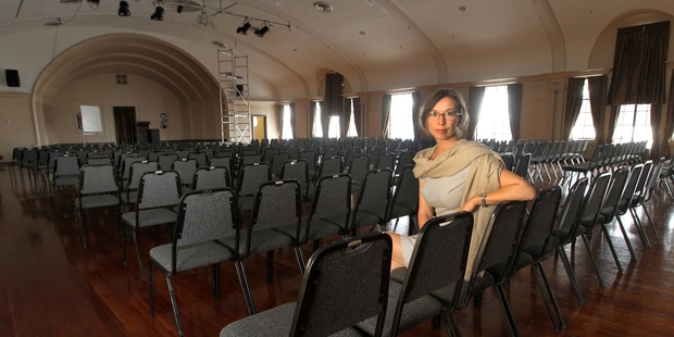 PROBLEMS: Hawke's Bay Opera House CEO Christine Spring, seated in The Assembly Room, which has been closed due to earthquake concerns. It was all set up for a show by Bill Haley Junior and the Comets, which has been relocated to Lindisfarne College, Hastings. PHOTO/DUNCAN BROWN HBT141117-01
