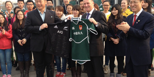 John Key swaps rugby jerseys with China Agricultural University President Ke Bingsheng. Photo / Claire Trevett