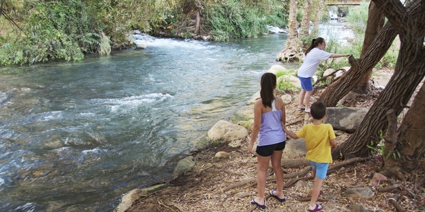 Children on the banks of the River Jordan, which today is a trickle compared to the mighty waterway it was said to be in Moses' time.