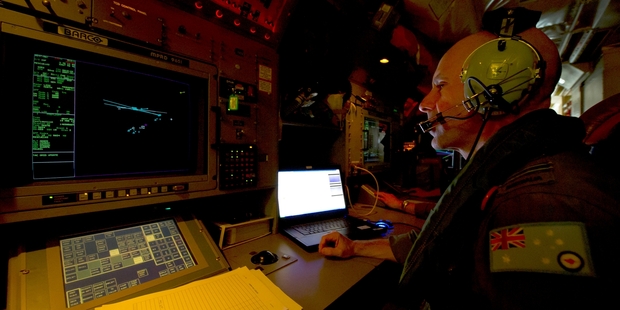 Flight Lieutenant Smokey Dawson (above) of the Royal Australian Air Force tracks the flow of information on an AP-3C Orion during the search.