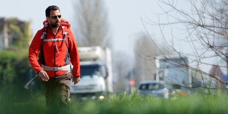 French rogue trader Jerome Kerviel walks on a road to leave Modena on March 19, 2014, during his trek from Rome to Paris "against the tyranny of the markets". Photo / AFP