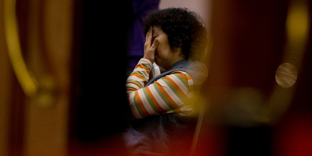 A relative of Chinese passengers aboard the missing Malaysia Airlines Flight MH370 waits for a news briefing by the Airlines' officials. Photo / AP
