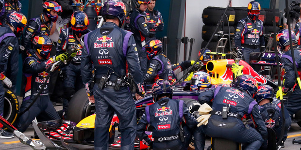 Red Bull mechanics perform a pit stop on the car driven by Daniel Ricciardo. Photo / AP