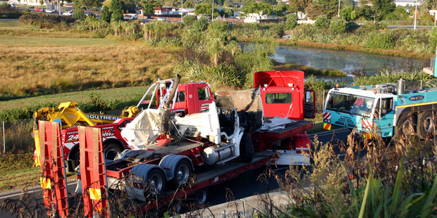 The driver of an articulated truck was killed when the vehicle crashed through a barrier near the SH20/SH1 intersection on the Southbound link from SH1 to SH20, Manukau. Photo / SNPA