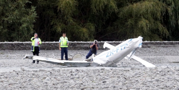 A police photographer at the scene of yesterday's plane crash which killed two men. Photo/Paul Taylor