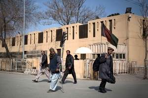 Afghans walk by the Serena hotel in downtown Kabul, Afghanistan. Photo / AP