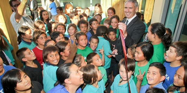 OPENING DAY: Hastings mayor Lawrence Yule surrounded by schoolchildren, cuts the ribbon to open the refurbished Flaxmere Community Centre. PHOTO/WARREN BUCKLAND HBT141282-01
