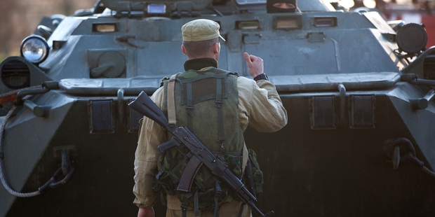 A pro-Russian soldier directs an armoured personnel carrier before the Ukrainian military base in Crimea was seized by Russian troops. Photo / AP