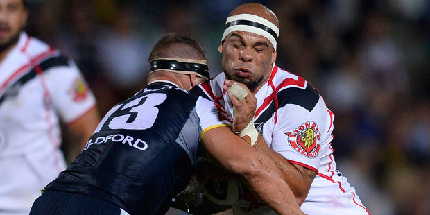 Sam Rapira of the Warriors is tackled by Tariq Sims of the Cowboys. Photo / Getty Images