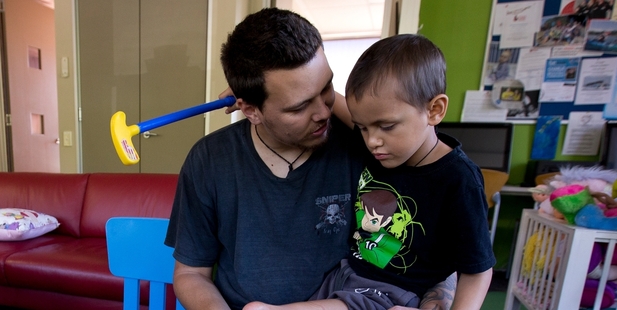 Renata Tane with his son Renata, who had surgery to remove some of his leg and reattach the lower part at the mid-thigh with the foot pointing backwards. Photo / Dean Purcell