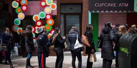 People wait in line to try out the Cupcake ATM created by Sprinkles bakery in New York City. Photo / AFP