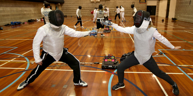 In Auckland Grammar's gym, Rachel Grunwell learns a valuable lesson from fencing coach Rob Ogg: the mind must outpace the foil or sword. Photo / Getty Images