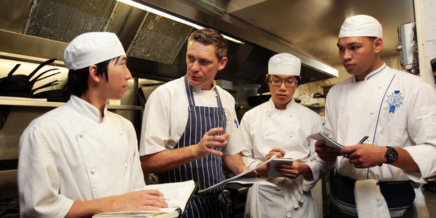 Chefs Sing Hang, Geoff Scott, Danny Byun and Rob Urquhart brainstorm recipe ideas. Photo / Doug SHerring