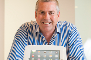 Cam Scott with a cash register, one of many products from his company which offers cloud-based support. Photo / Greg Bowker