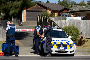 Police at the scene on Cartmel Ave, Massey where an 18-month-old girl died after she was run over in the driveway. Photo / Dean Purcell