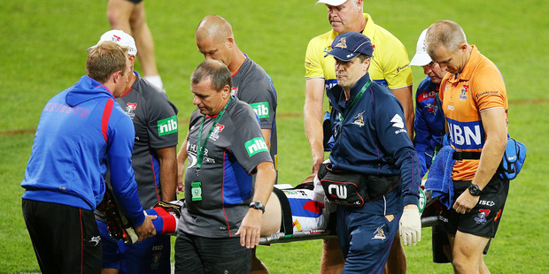 Alex McKinnon of the Knights is carried off an a stretcher. Photo / Getty Images