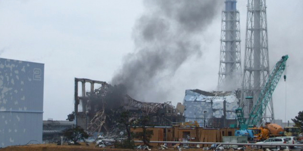 FILE - In this March 21, 2011 file photo released by Tokyo Electric Power Co. (TEPCO), smoke rises from the Unit 3 reactor of the tsunami-damaged Fukushima Dai-ichi nuclear plant in Okuma town, Fukush