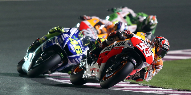 Spanish MotoGP rider Marc Marquez of the Repsol Honda Team , right, and Italian MotoGP rider Valentino Rossi of the Movistar Yamaha MotoGP team round a corner during the MotoGP opener in Qatar.