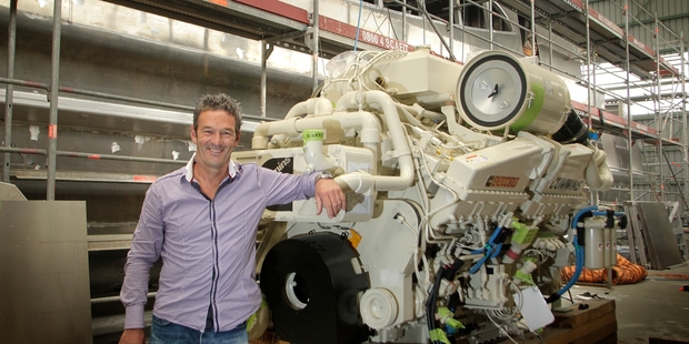 Myles Fothergill and a Cummins marine engine are dwarfed by the 338-passenger Fullers ferry behind them. Photo/Bevan Conley
