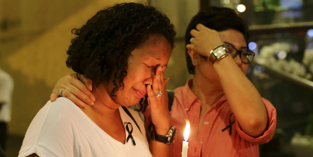 A woman wipes her tears as she joins a ceremony in memory of passengers on board the missing Malaysia Airlines Flight MH370 in Kuala Lumpur. Photo / AP