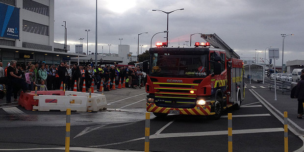 A crowd gathered outside Auckland Airport after it was evacuated this morning. Photo / Brendan Manning