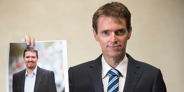 Look at me now...Conservative leader Colin Craig witha picture of himself before losing 30kg. Photo / Greg Bowker