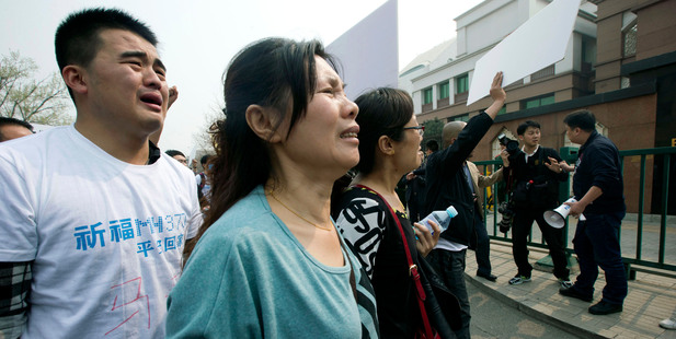 Relatives of passengers onboard Malaysia Airlines Flight 370 protest outside the Malaysian Embassy in Beijing, China. Photo / AP