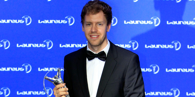 Formula One driver Sebastian Vettel displays his Laureus World Sportsman of the Year trophy. Photo / AP