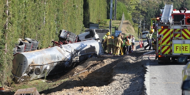 A Hamilton-bound truck rolled down a 2m bank into a ditch, trapping the driver. Photo/John Borren