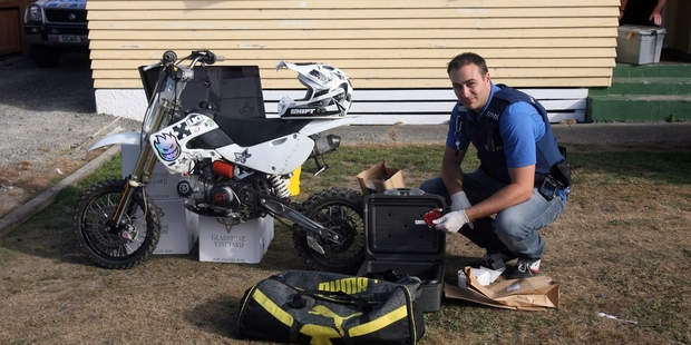 Constable Joe Nelly with some of the stolen property recovered from a Lansdowne property yesterday. PHOTO/LYNDA FERINGA