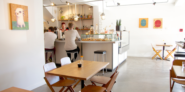 Concrete floors and white walls give an industrial feel to LOT23's cafe. Photo / Ben Crawford